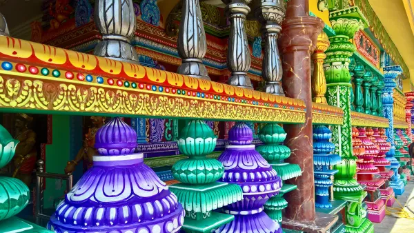 Vibrant and colorful pillars of Batu Caves, Malaysia, showcasing intricate designs and traditional Hindu art.